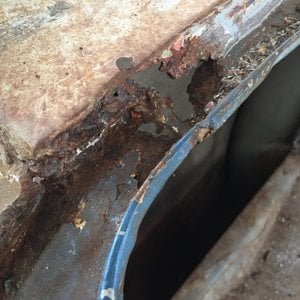 Some rust in the trunk channel toward the back on the driver's side